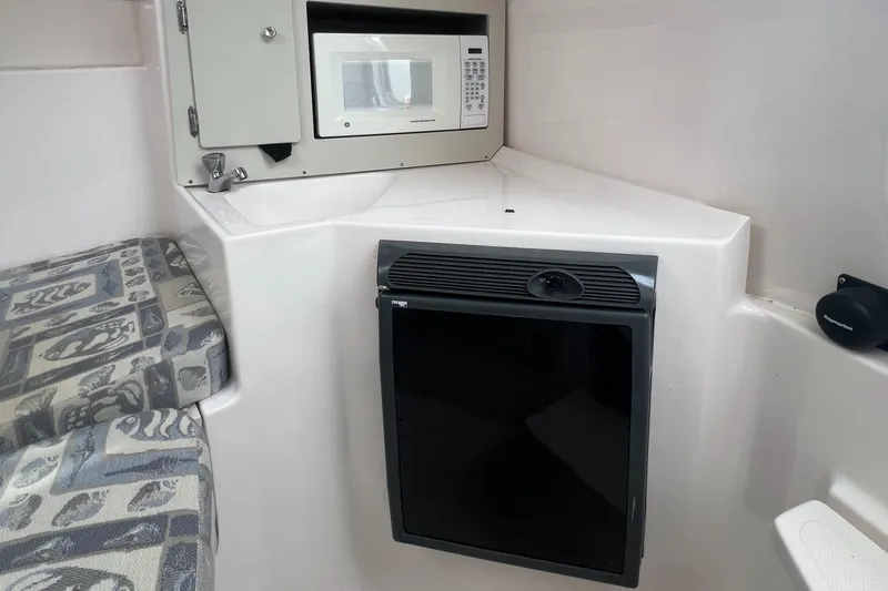 Slide: The Image of 2006 Polar 2300 Walkaround cabin interior with microwave and mini fridge. - 9