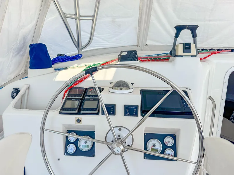 Slide: The Image of Steering wheel and controls of a 2000 Manta 42 sailboat cockpit. - 10
