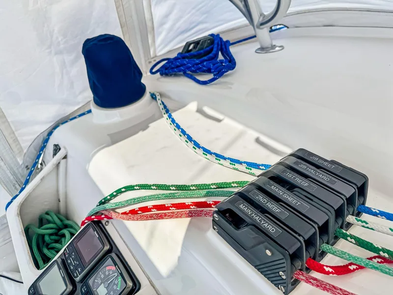 Slide: The Image of Sailing equipment on a 2000 Manta 42 catamaran with colorful ropes and control panels. - 13