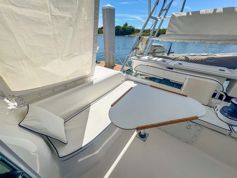 Slide: The Image of Manta 42 yacht cockpit with seating and table, docked by the water, 2000 model. - 16