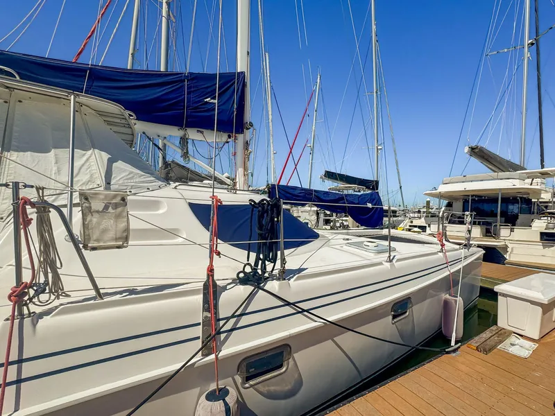 Slide: The Image of Sailboat Manta 42, 2000 model, docked at marina under clear blue sky. - 2