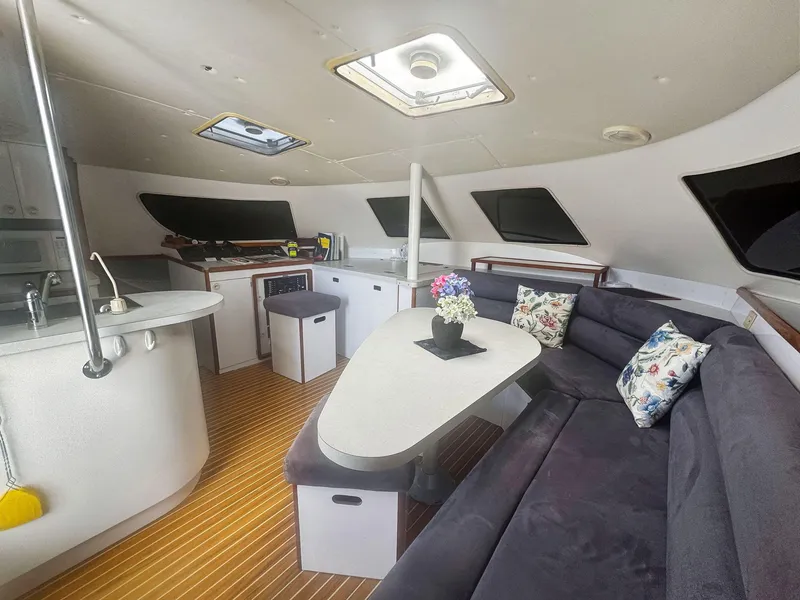 Slide: The Image of Interior of 2000 Manta 42 yacht with modern kitchen and cozy seating area. - 21