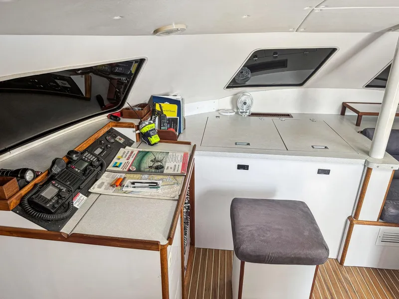 Slide: The Image of Navigation station inside 2000 Manta 42 yacht with equipment and seating. - 22