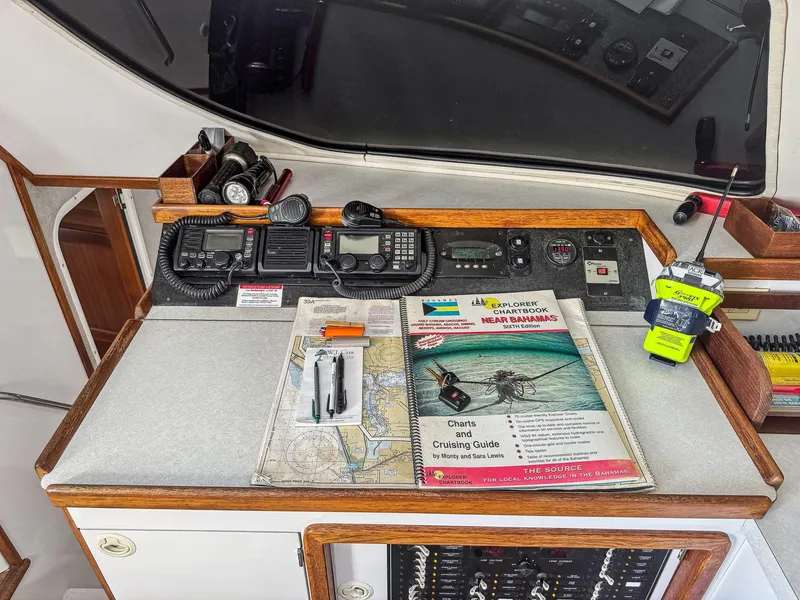Slide: The Image of Navigation station on a 2000 Manta 42 catamaran with maps and communication equipment. - 23