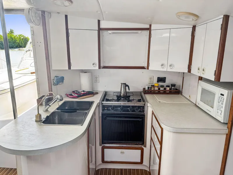 Slide: The Image of Compact kitchen in a 2000 Manta 42 yacht with stove, sink, and microwave. - 27