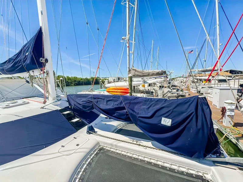 Slide: The Image of Sailboats docked at marina, featuring a 2000 Manta 42 catamaran under clear blue skies. - 3