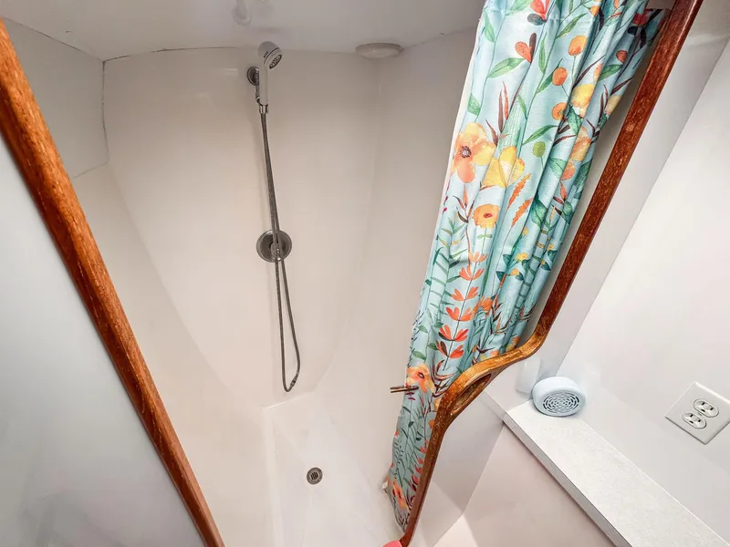 Slide: The Image of Shower area in 2000 Manta 42 boat with floral curtain and handheld showerhead. - 35