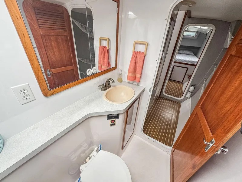 Slide: The Image of Bathroom interior of 2000 Manta 42 yacht with sink, mirror, and wooden accents. - 36