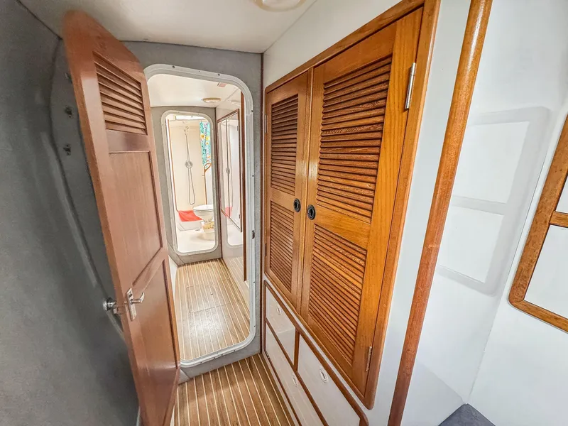 Slide: The Image of Interior hallway of a 2000 Manta 42 yacht with wooden doors and flooring. - 37