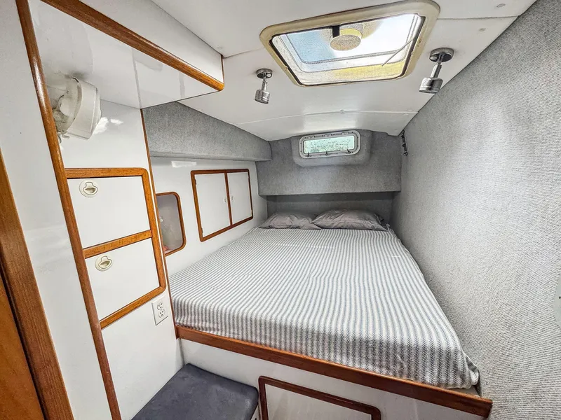 Slide: The Image of Cozy cabin interior of 2000 Manta 42 sailboat with bed and storage. - 39