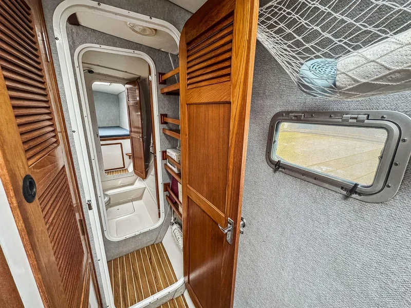 Slide: The Image of Interior of 2000 Manta 42 sailboat with wooden doors and compact cabin space. - 43