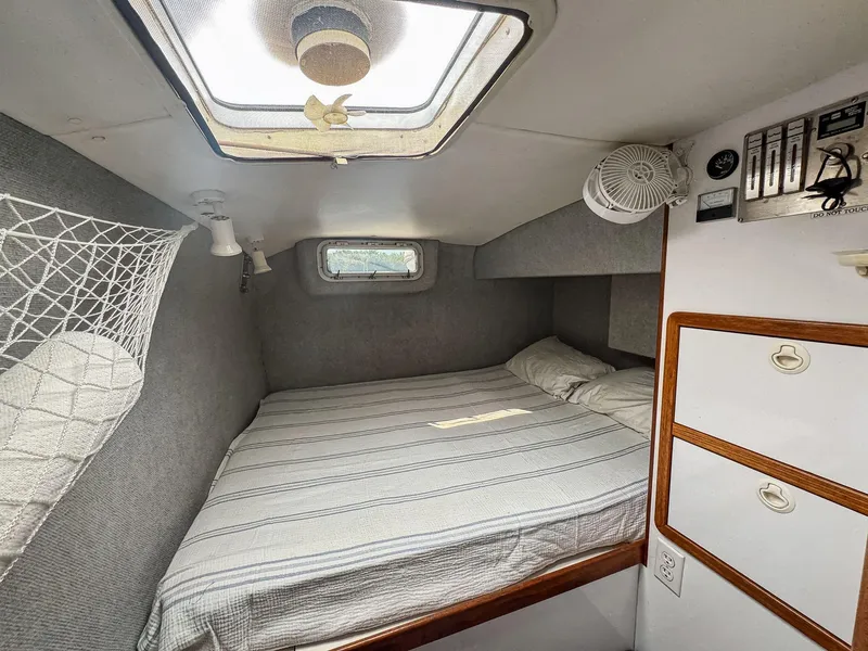 Slide: The Image of Cozy cabin interior of 2000 Manta 42 sailboat with bed and storage. - 44