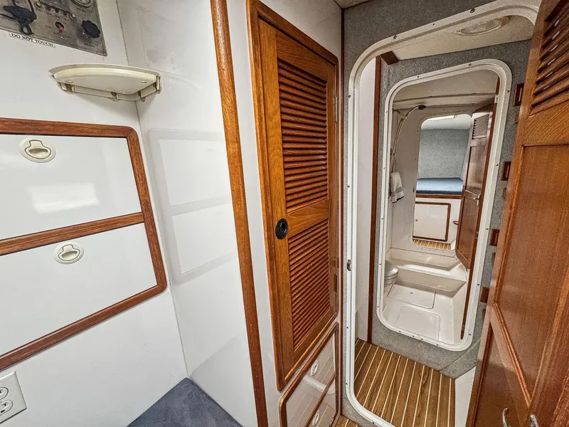 Slide: The Image of Interior of 2000 Manta 42 sailboat with wooden cabinetry and compact design. - 46