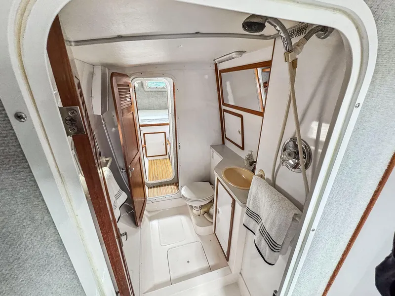 Slide: The Image of Bathroom interior of 2000 Manta 42 yacht, featuring shower, sink, and toilet. - 49