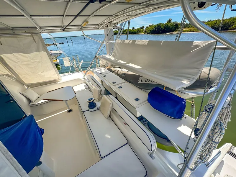 Slide: The Image of Spacious deck of 2000 Manta 42 catamaran with seating and scenic water view. - 6