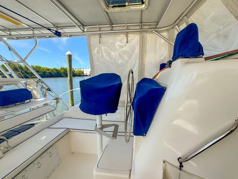 Slide: The Image of Interior view of 2000 Manta 42 sailboat with blue-covered seating and steering wheel. - 8