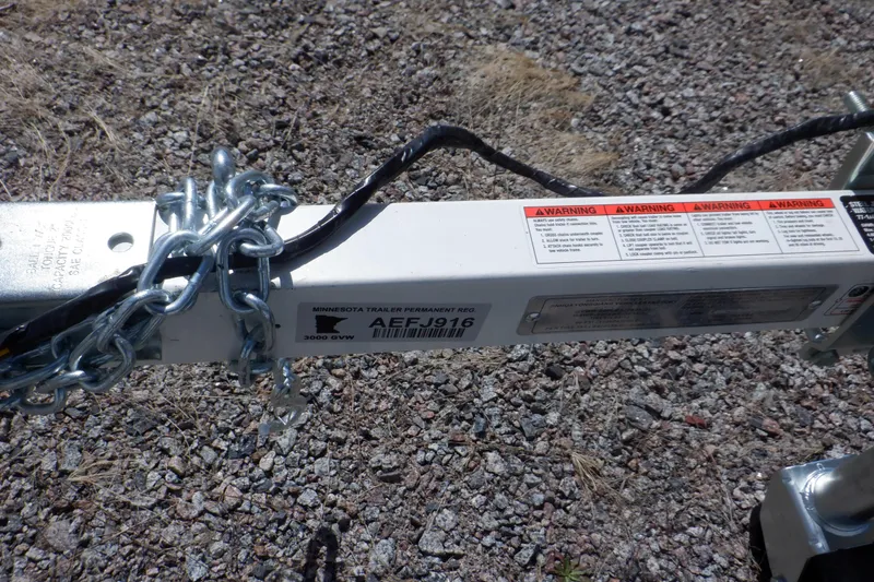 Slide: The Image of Chain-secured trailer hitch on gravel, Walker Bay Odyssey 325 ST, 2015 model. - 10