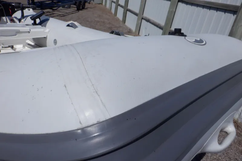 Slide: The Image of Walker Bay Odyssey 325 ST inflatable boat, 2015 model, docked outdoors. - 11