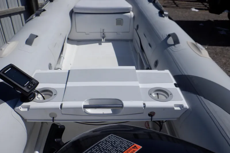 Slide: The Image of 2015 Walker Bay Odyssey 325 ST inflatable boat interior with console and seating. - 24