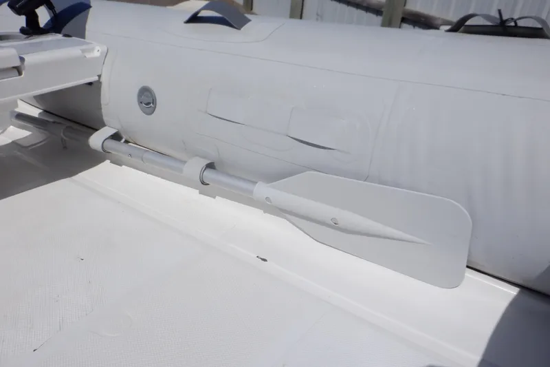 Slide: The Image of 2015 Walker Bay Odyssey 325 ST inflatable boat with attached oar. - 34