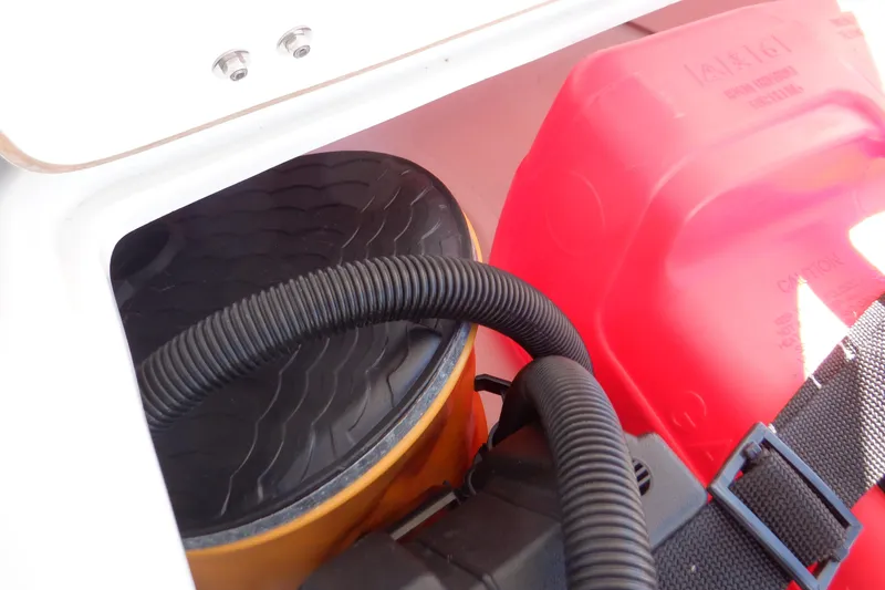 Slide: The Image of Storage compartment of 2015 Walker Bay Odyssey 325 ST with hose and red container. - 37