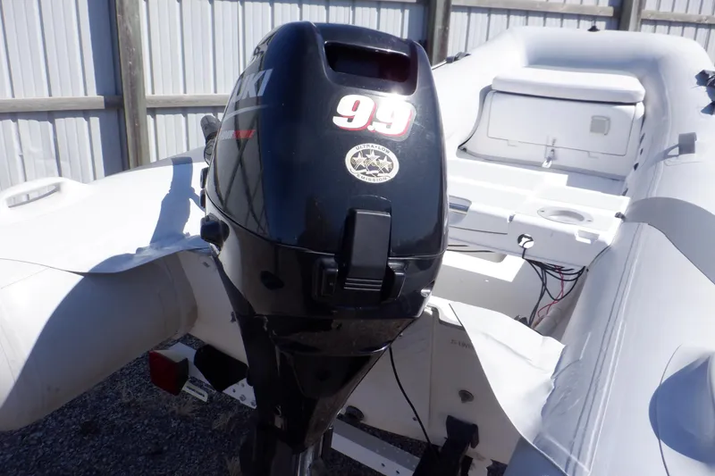 Slide: The Image of 2015 Walker Bay Odyssey 325 ST with Suzuki outboard motor, docked in a sunny marina. - 4