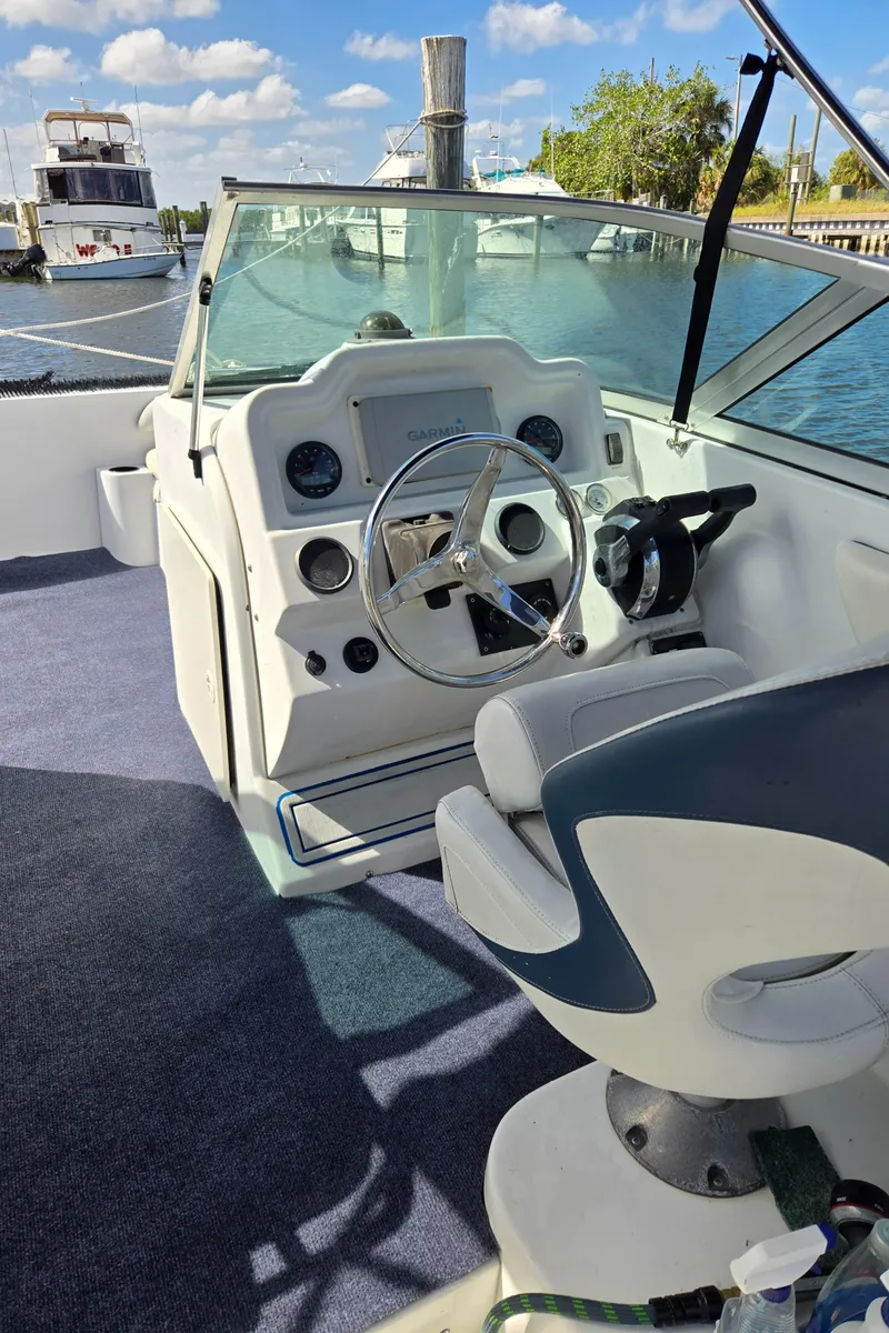 Slide: The Image of 2003 Glacier Bay 2240 SX Renegade boat cockpit with steering wheel and controls. - 10