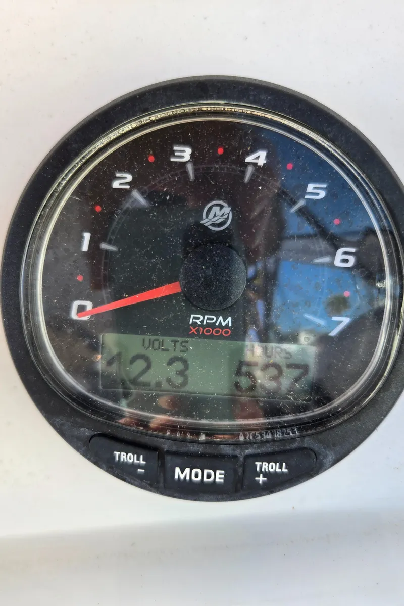 Slide: The Image of Close-up of a 2003 Glacier Bay 2240 SX Renegade tachometer showing RPM and voltage readings. - 11