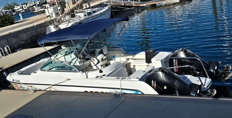 Slide: The Image of 2003 Glacier Bay 2240 SX Renegade boat docked with twin engines and canopy. - 3