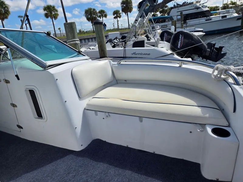 Slide: The Image of 2003 Glacier Bay 2240 SX Renegade boat with cushioned seating, docked at marina. - 4