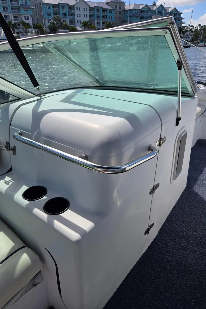 Slide: The Image of 2003 Glacier Bay 2240 SX Renegade boat interior with windshield and cup holders. - 9