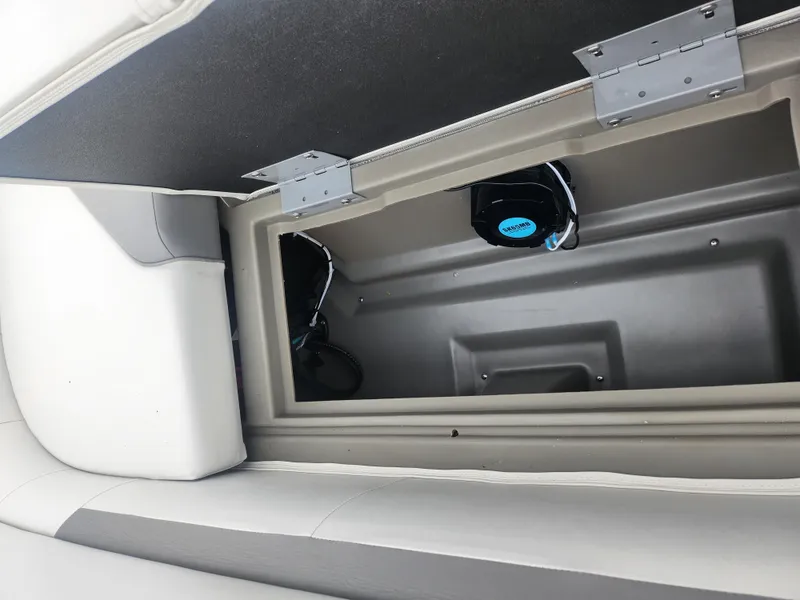 Slide: The Image of Storage compartment in a 2021 Godfrey Sweetwater 2086 C boat, featuring a speaker system. - 15