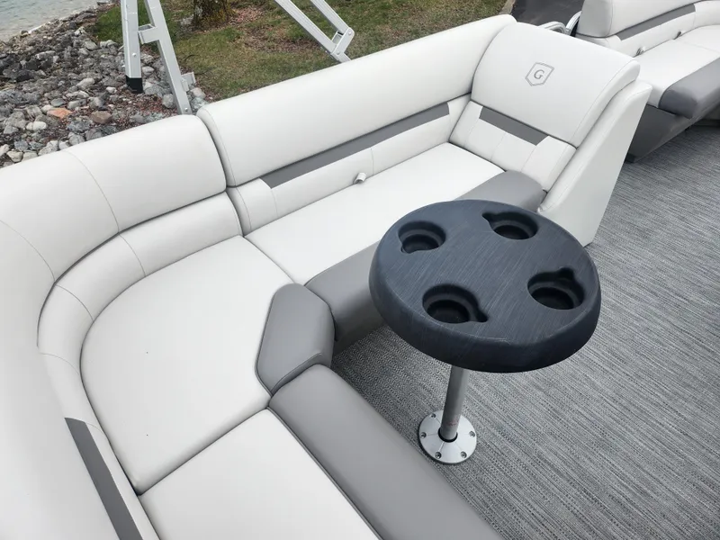 Slide: The Image of 2021 Godfrey Sweetwater 2086 C pontoon boat interior with cushioned seating and cup holder table. - 16