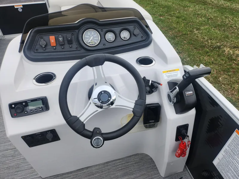 Slide: The Image of Steering console of 2021 Godfrey Sweetwater 2086 C pontoon boat, featuring gauges and controls. - 18