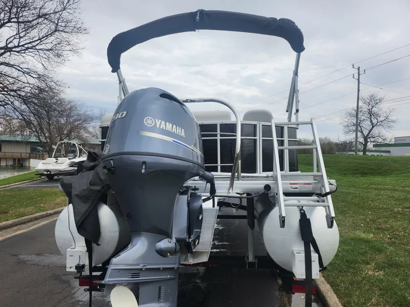 Slide: The Image of 2021 Godfrey Sweetwater 2086 C pontoon boat with Yamaha engine, parked outdoors. - 2