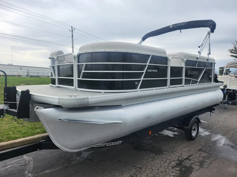 Slide: The Image of 2021 Godfrey Sweetwater 2086 C pontoon boat on trailer, parked outdoors. - 5