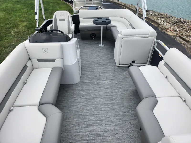 Slide: The Image of 2021 Godfrey Sweetwater 2086 C pontoon boat interior with plush seating and table. - 9