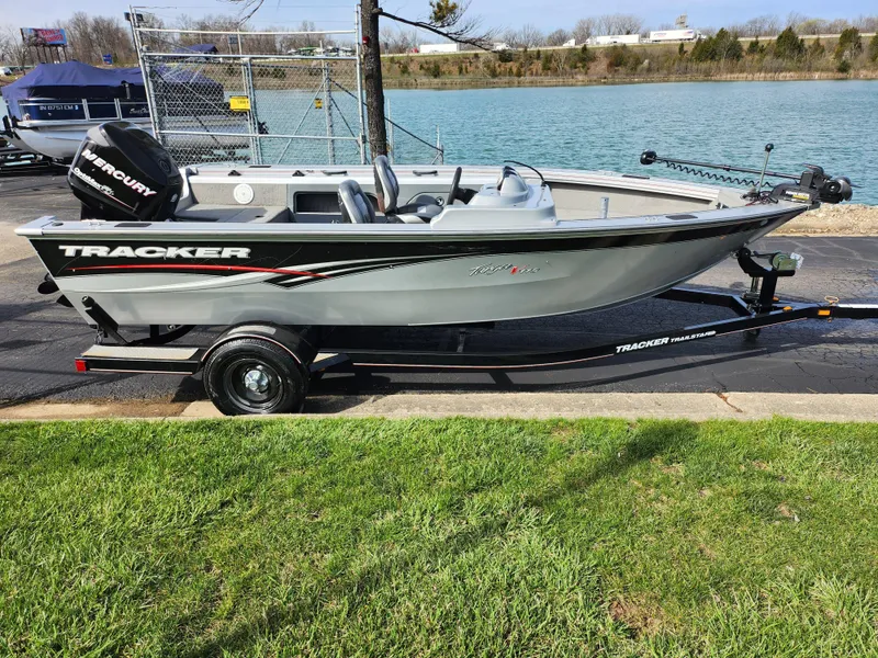Slide: The Image of 2007 Tracker Targa 175 SC boat on trailer by a lake. - 10