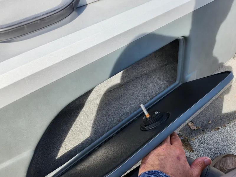 Slide: The Image of 2007 Tracker Targa 175 SC boat interior detail with hand adjusting a component. - 17