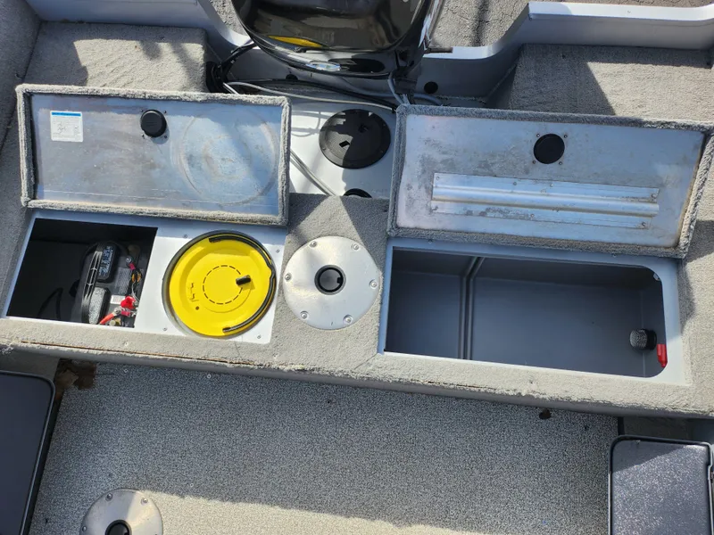Slide: The Image of 2007 Tracker Targa 175 SC boat storage compartments with open lids and visible equipment. - 24