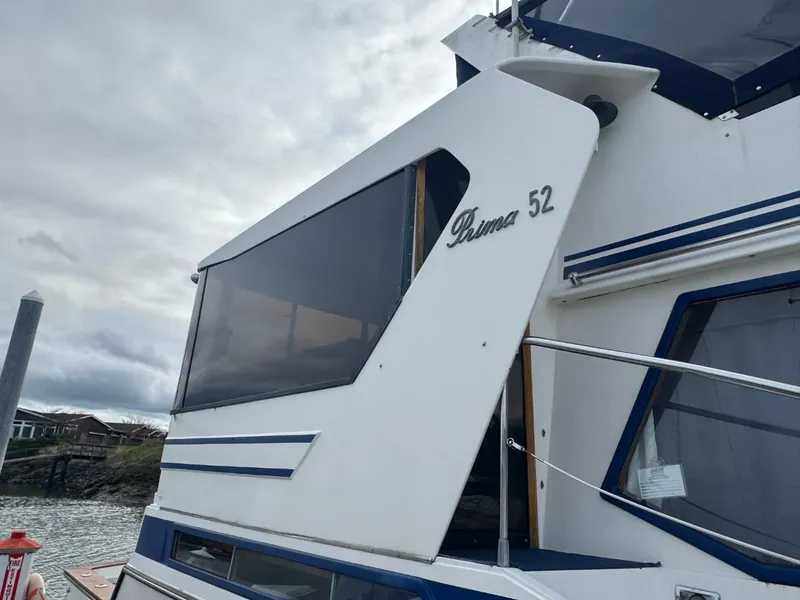 Slide: The Image of 1989 Prima 52 Cockpit Motor Yacht docked, showcasing sleek design and modern features. - 11