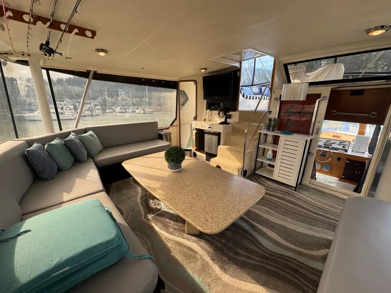 Slide: The Image of Luxurious 1989 Prima 52 Cockpit Motor Yacht interior with spacious seating and elegant decor. - 12