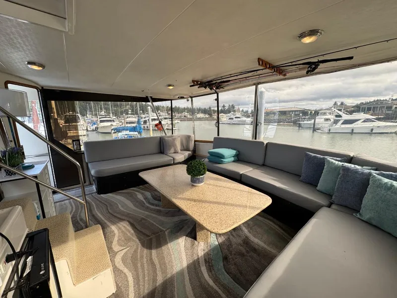 Slide: The Image of Luxurious 1989 Prima 52 Cockpit Motor Yacht interior with spacious seating and marina view. - 13