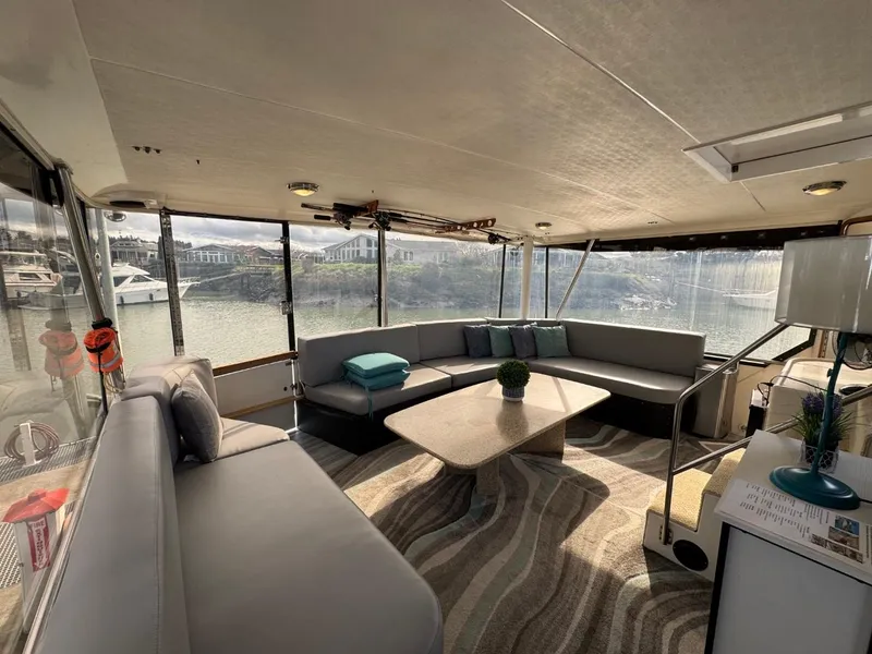 Slide: The Image of Luxurious interior of 1989 Prima 52 Cockpit Motor Yacht with spacious seating and scenic views. - 14