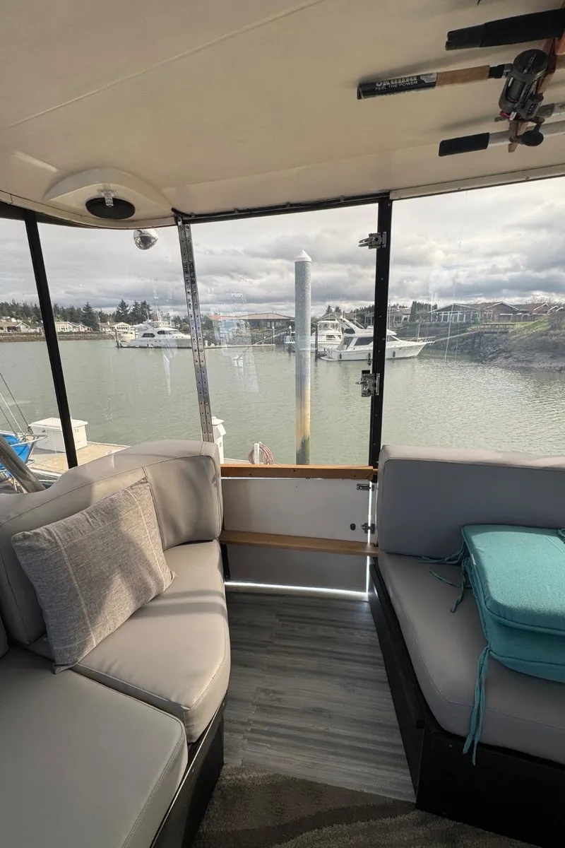 Slide: The Image of Interior view of 1989 Prima 52 Cockpit Motor Yacht with marina backdrop. - 16