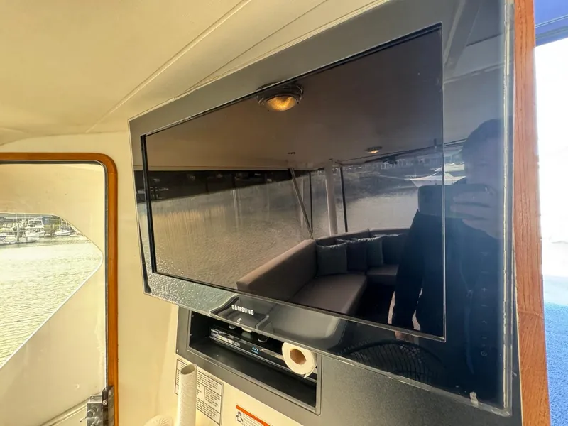 Slide: The Image of Flat-screen TV inside 1989 Prima 52 Cockpit Motor Yacht cabin. - 18