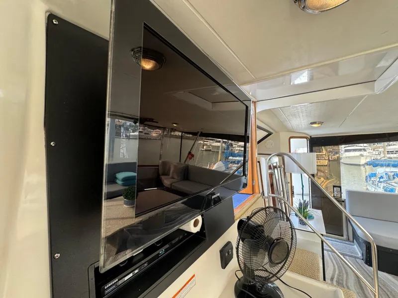 Slide: The Image of Interior of 1989 Prima 52 Cockpit Motor Yacht with TV and seating area. - 19