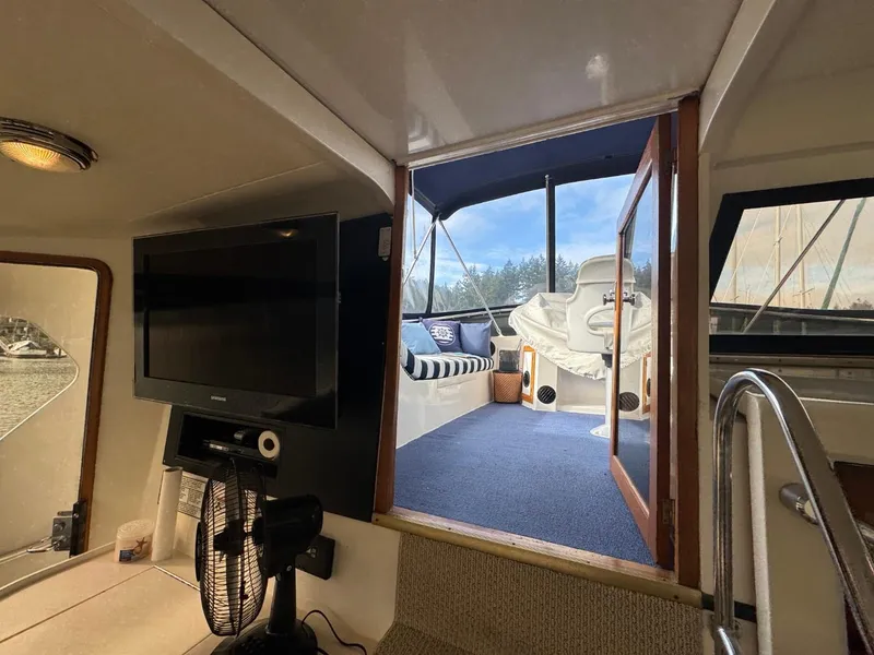 Slide: The Image of Interior view of 1989 Prima 52 Cockpit Motor Yacht with TV and outdoor seating area. - 20
