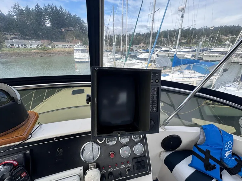 Slide: The Image of Cockpit view of 1989 Prima 52 Motor Yacht with navigation equipment and marina background. - 25