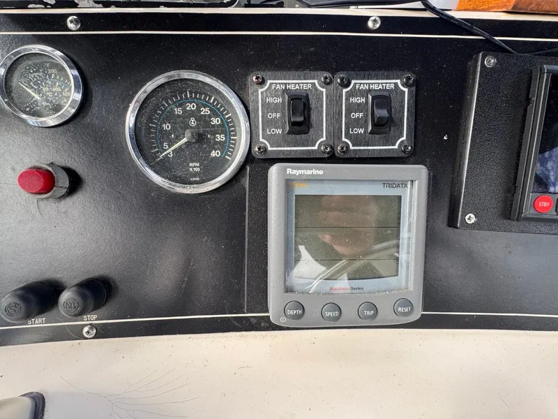 Slide: The Image of Control panel of a 1989 Prima 52 Cockpit Motor Yacht with gauges and switches. - 26